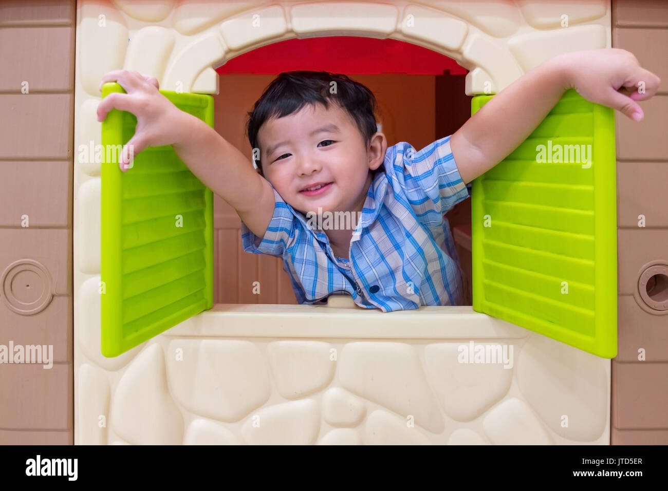Kid Window Toy Happy Asian child Boy playing with window toy house in playground Stock ...