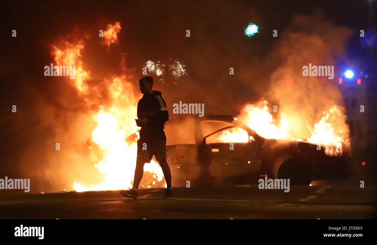 A car on fire in the North Queen Street area of Belfast, close to the site of a contentious bonfire. Stock Photo