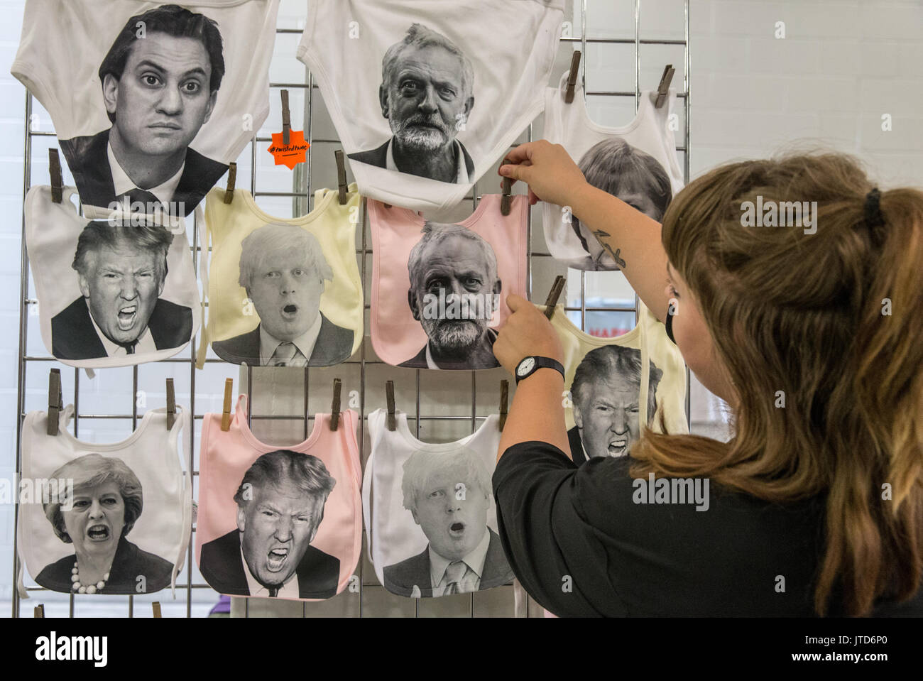 A woman pins up Political beer bibs for sale at the Great British Beer Festival in Olympia, London. It is the 40th year of the Beer festival Stock Photo