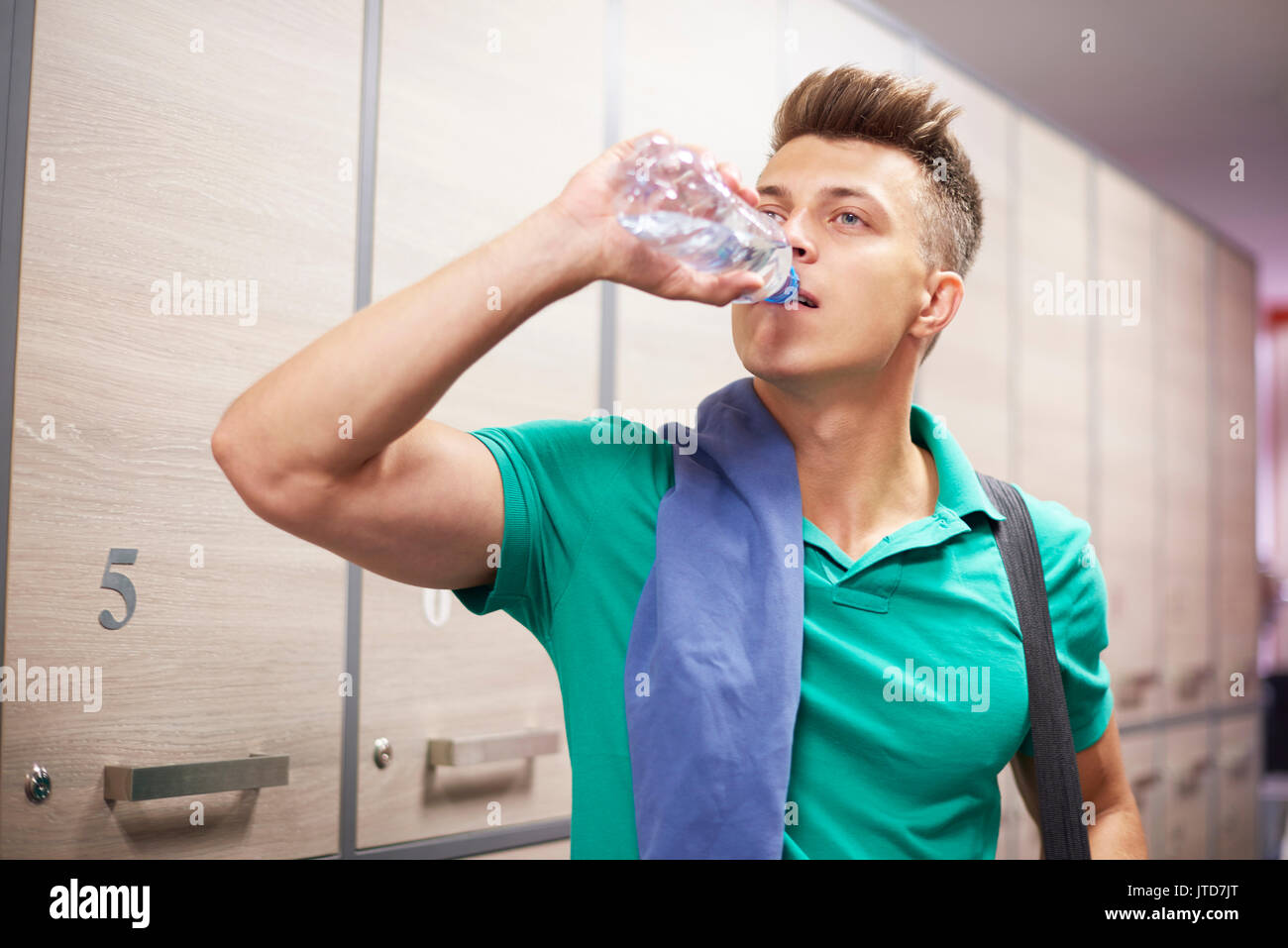 Thirsty man after tiring traning at the gym Stock Photo