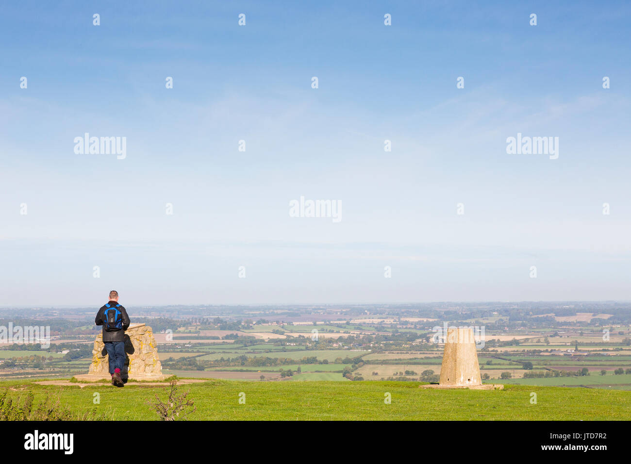 UK weather, 23rd September 2015. A lone walker with a backpack pauses at a map near the trig point on Ivinghoe Beacon. Stock Photo