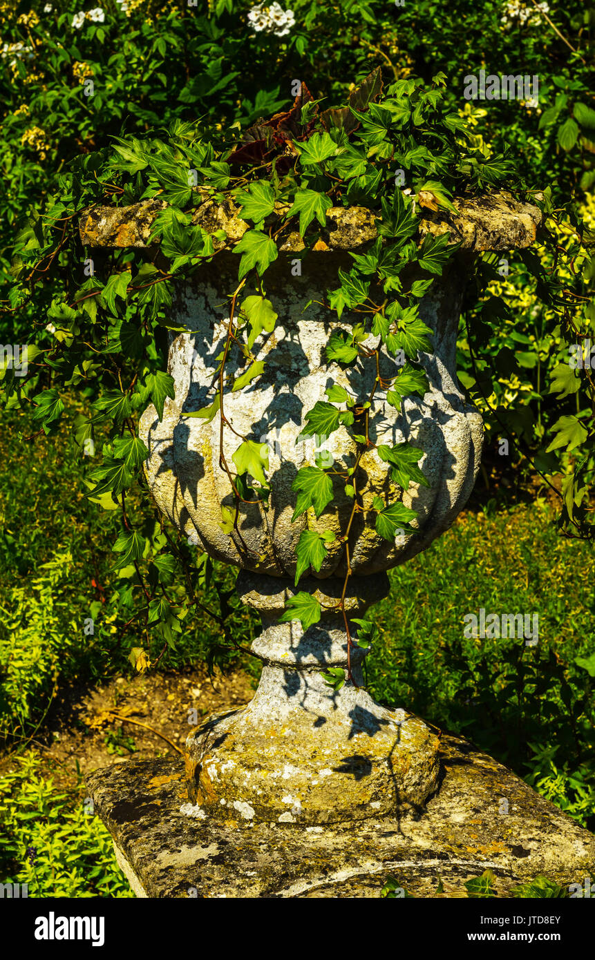 Concrete flower pots in the garden on a pedestal stylized antique, a