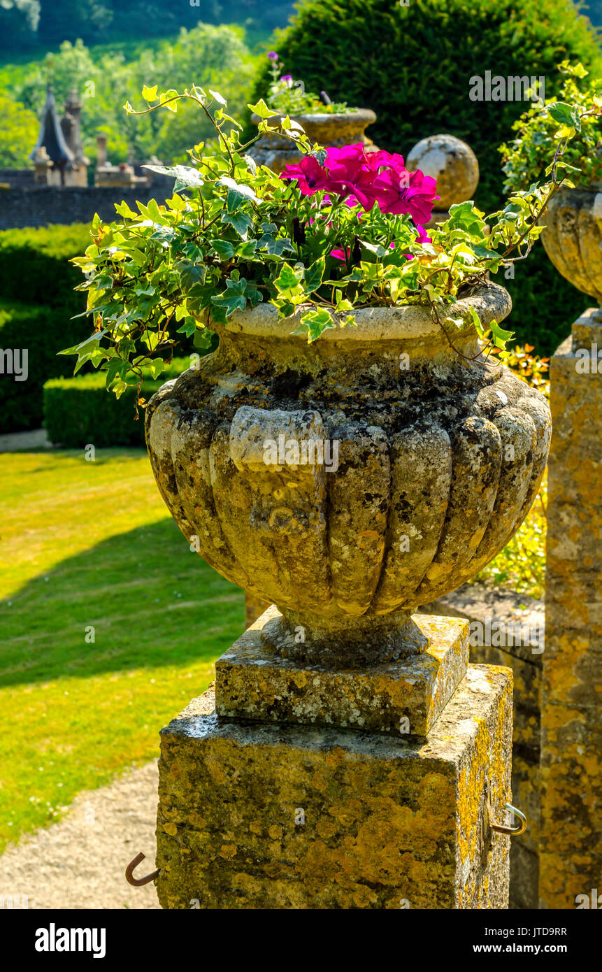 Concrete flower pots in the garden on a pedestal stylized antique, a