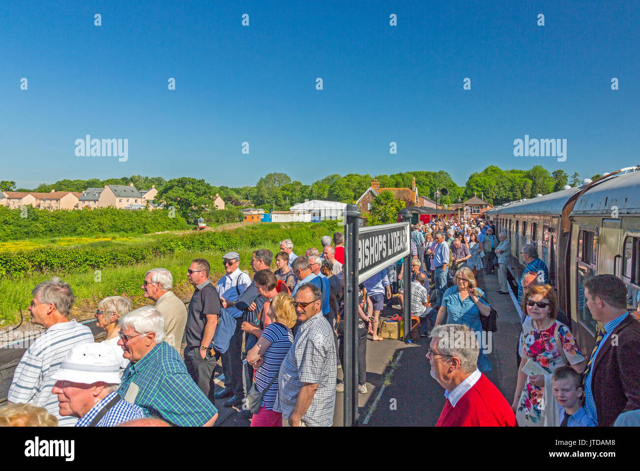 A platform packed with people waiting for the arrival of LNER steam locomotive 'Flying Scotsman' at Bishops Lydeard, West Somerset Railway, England UK Stock Photo