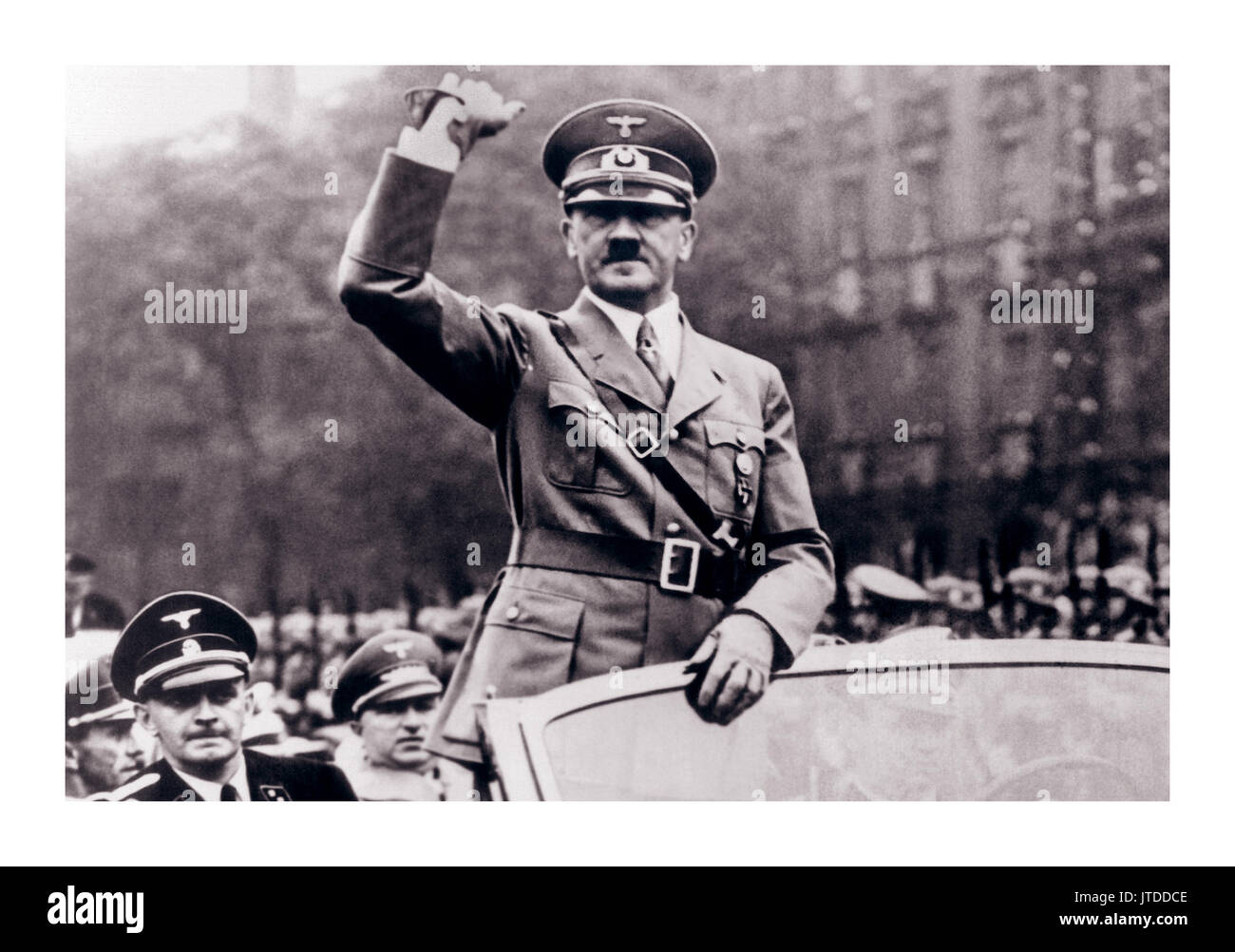 Fuhrer Adolf Hitler in uniform salutes the crowd from his open car on the occasion of the 15th anniversary of German Day in Coburg, Germany, in October 1937 Stock Photo