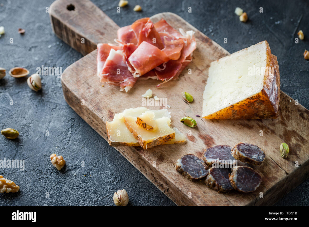 Cheese and meat platter. Spanish ham jamon serrano or Italian