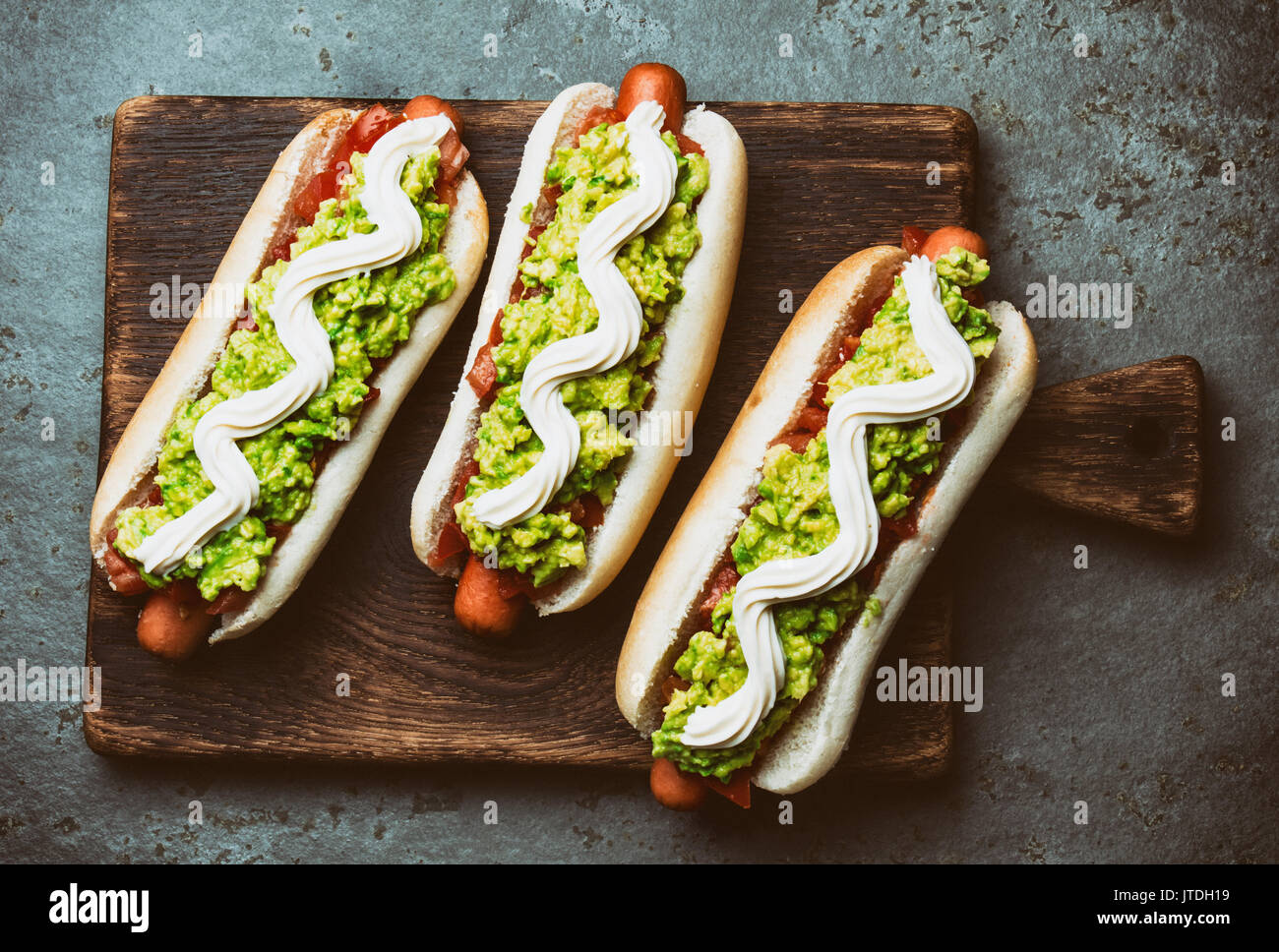 Chilean Completo Italiano. Hot dog sandwich with tomato, avocado and mayonnaise. Top view, copy space Stock Photo