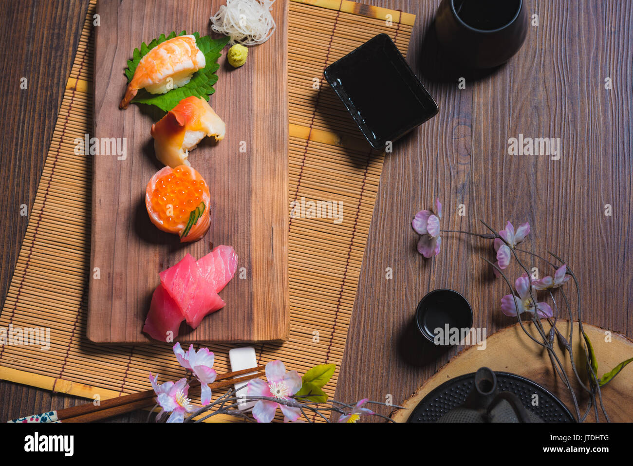 traditional Japanese cuisine. Process of eating sushi rolls or sushi set with salmon, selective focus Stock Photo
