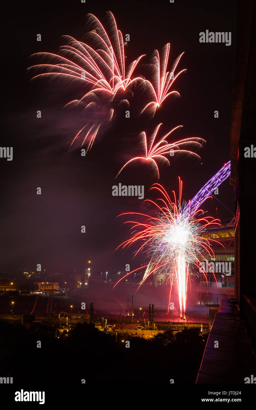 Fireworks light up the nights sky with Wembley Stadium lit arch in the background Stock Photo