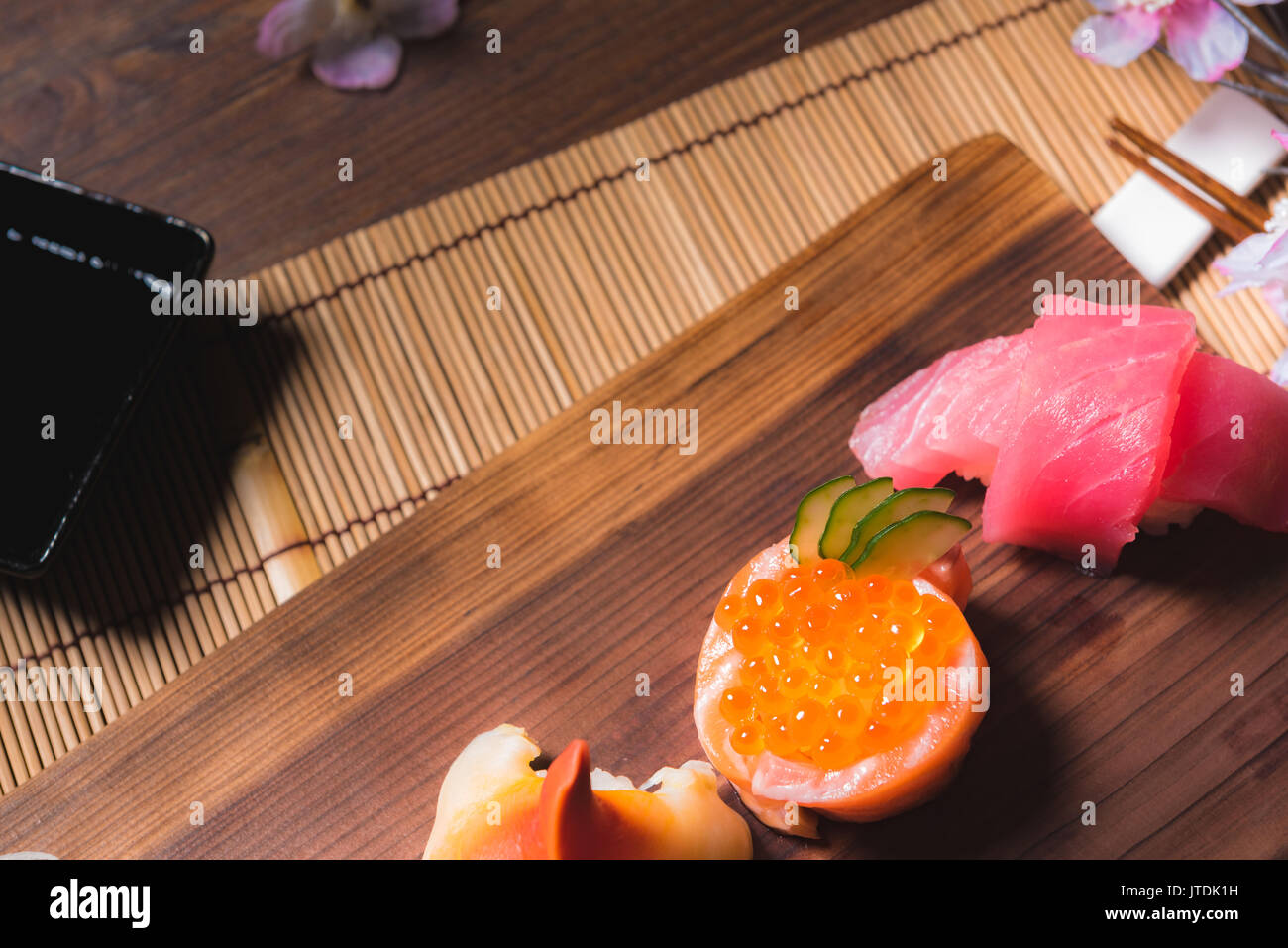 traditional Japanese cuisine. Process of eating sushi rolls or sushi set with salmon, selective focus Stock Photo