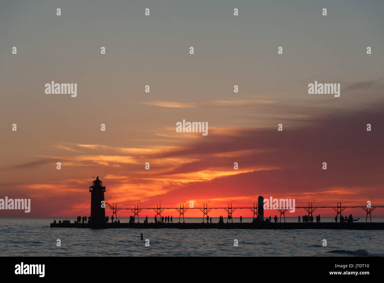 Dramatic view of lighthouse and pier at sunset, South Haven, Michigan. Stock Photo