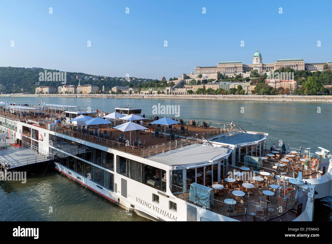 Viking River Cruises cruise boats with The Royal Palace on Castle Hill behind, Budapest, Hungary Stock Photo