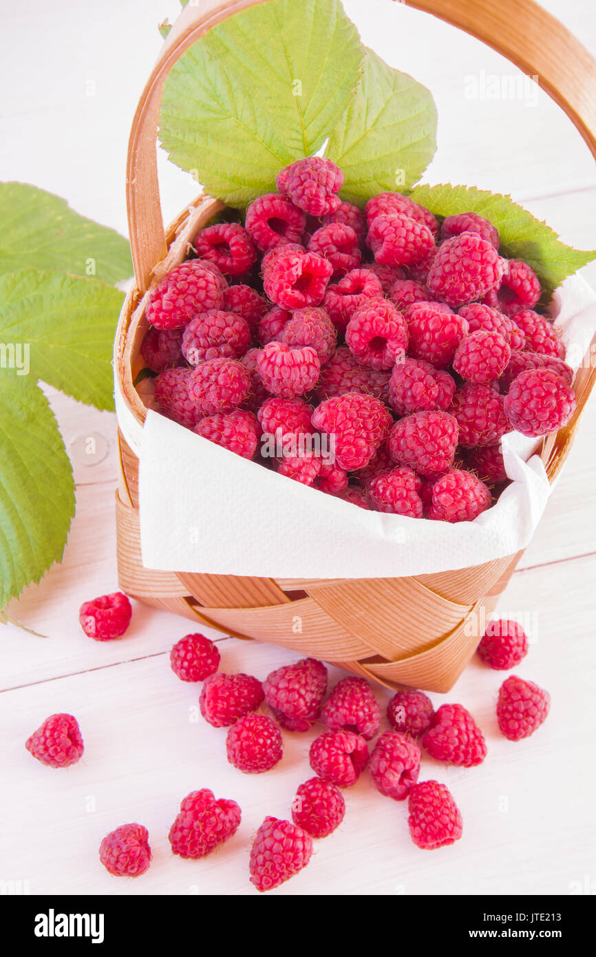 Littke Raspberry Picturee Fresh fruits raspberries in a wooden little punnet on a white table ...