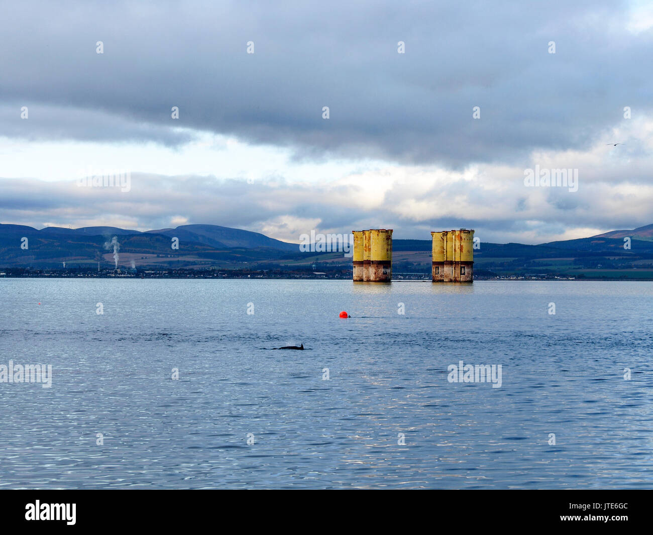 Scotland, Highlands, Partially Dismantled Drilling Rig, Sea Buoy, Dolphin, Yellow Drilling Rig Legs, Metal Structure, Mountaintop, Offshore Platform Stock Photo