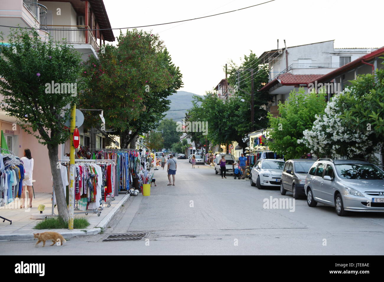 Asprovalta, summer resort in northern Greece on the Aegean Sea. Street in the evening. Visible numerous shops, taverns and strolling tourists. Stock Photo
