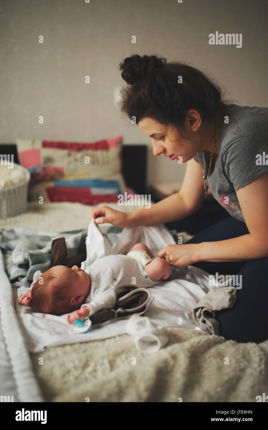 Mother changing baby's diaper hires stock photography and images Alamy