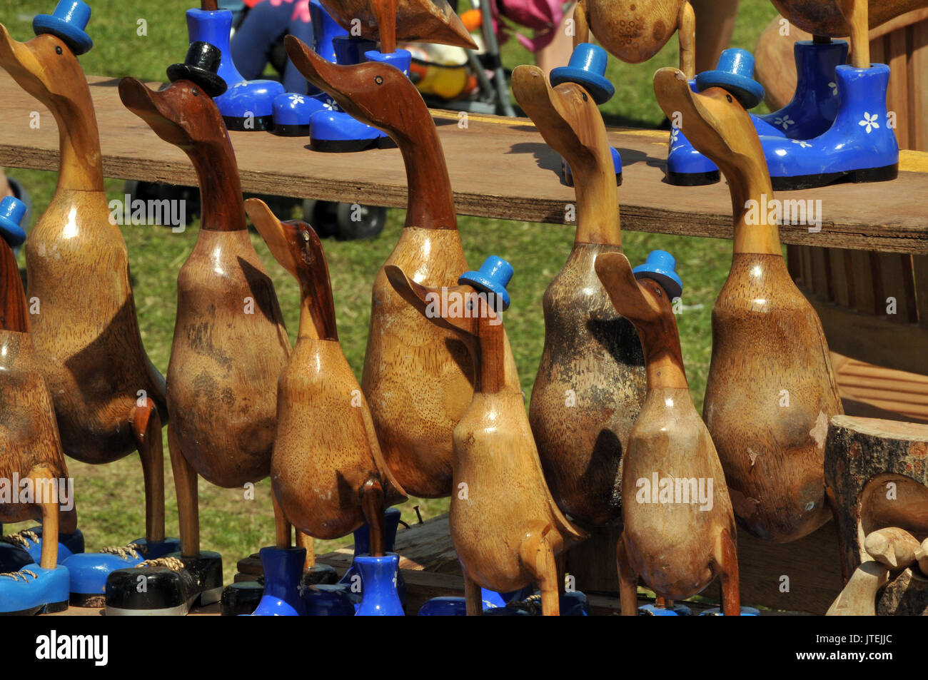 wooden ducks or carved garden statuary or ornaments on sale at a