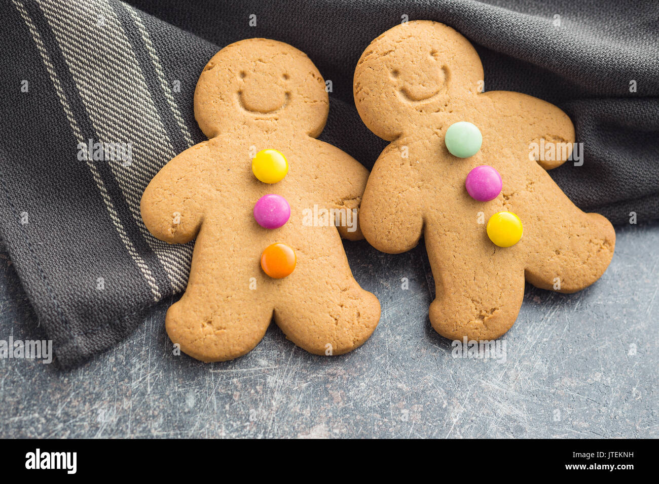 Two sweet gingerbread men on old kitchen table. Stock Photo