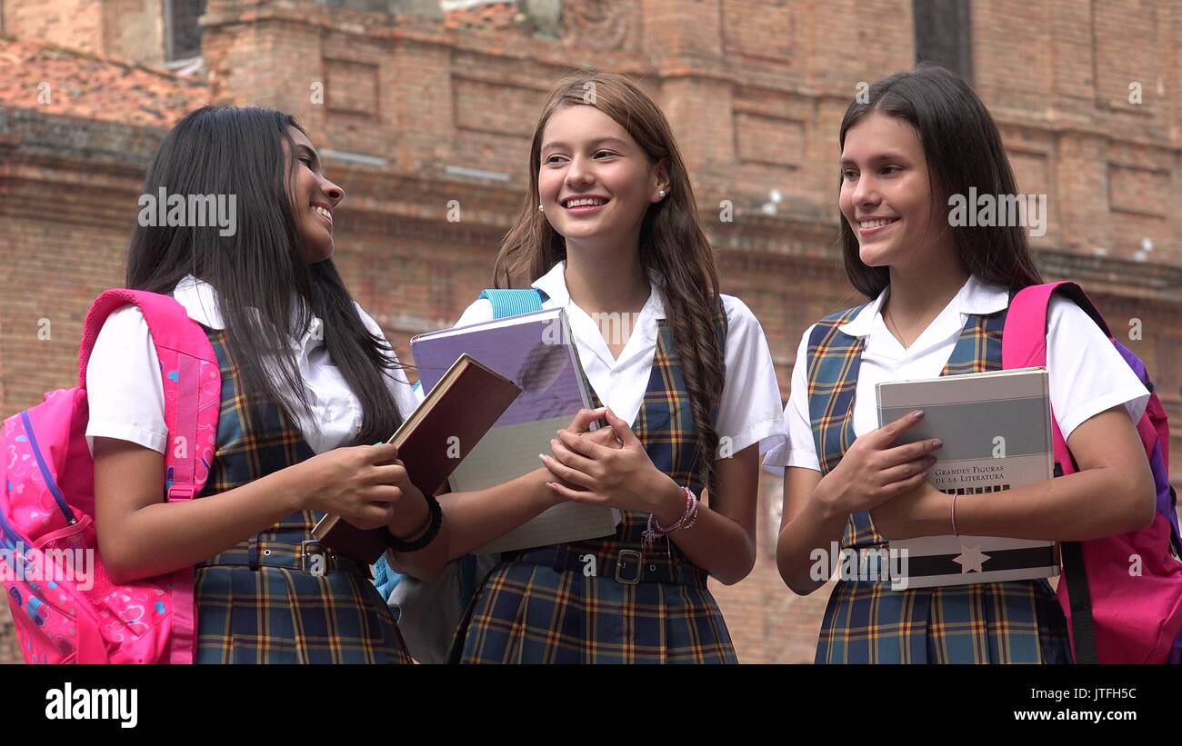 Happy School Girls In Uniform Holding Books Stock Photo - Alamy