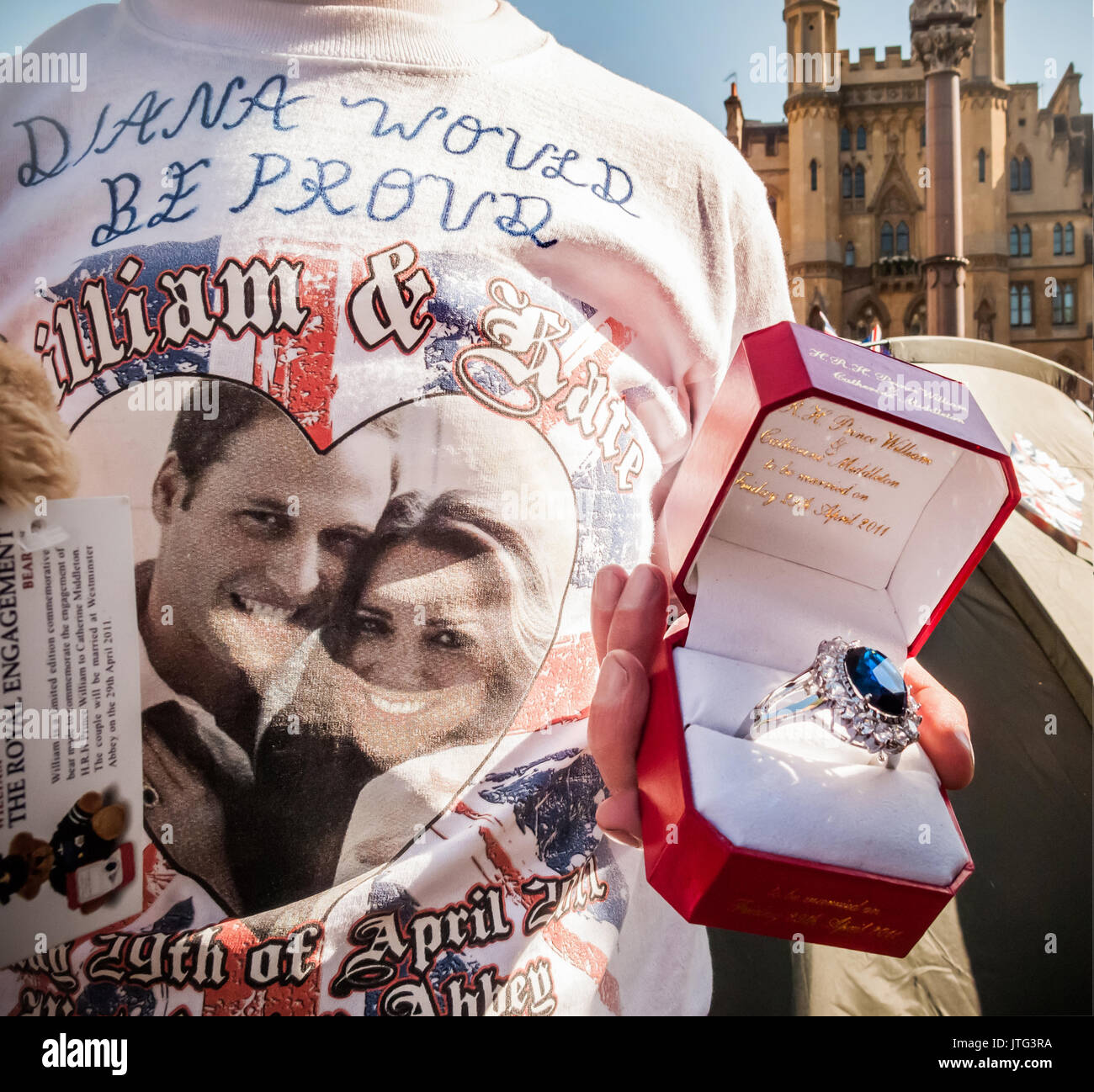 A royal fan outside Westminster Abbey in London displays a replica of Kate Middleton's engagement ring two days before the Royal wedding. Stock Photo