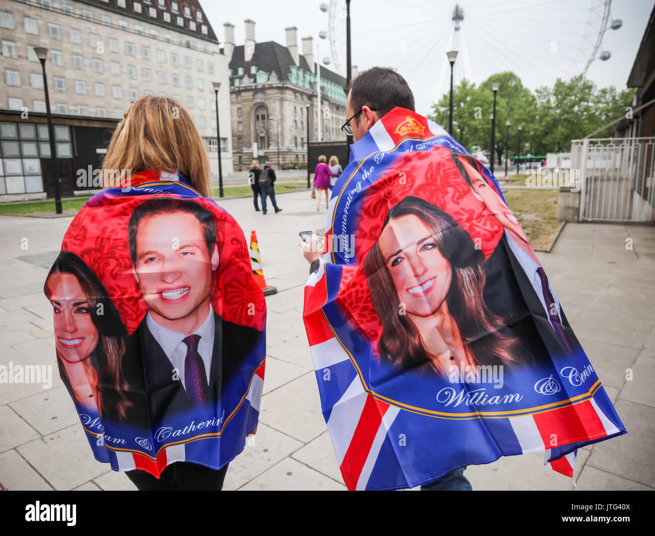 Royal fans wrapped in William and Kate celebration flags on the day of the Royal wedding of Prince William Wales and Kate Middleton. London, UK. Stock Photo