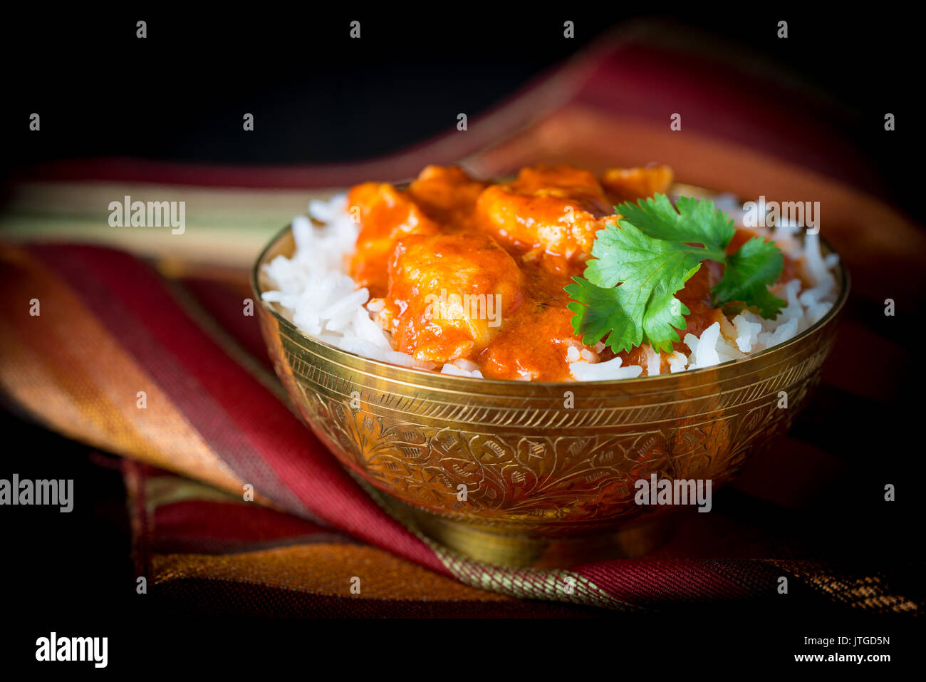 Bowl of butter chicken on a bed of basmati rice Stock Photo Alamy