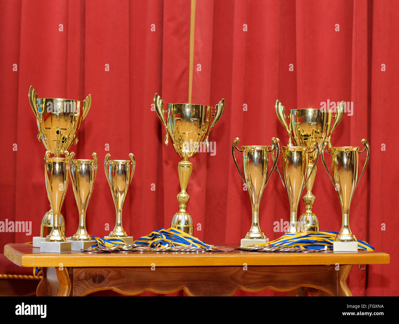Many golden award cups waiting for their winners Stock Photo