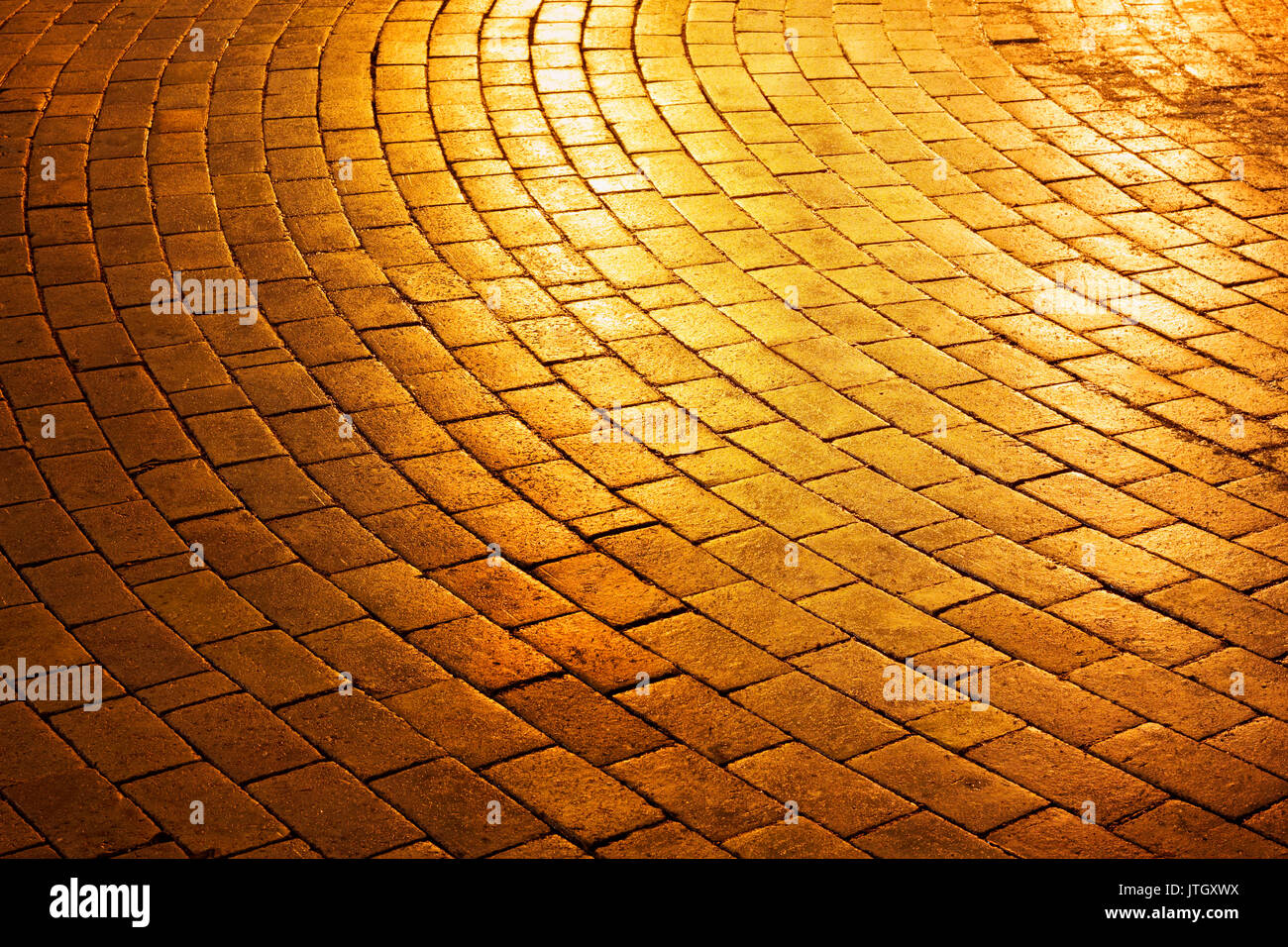 Golden brick circle shaped pavement road in the park Stock Photo