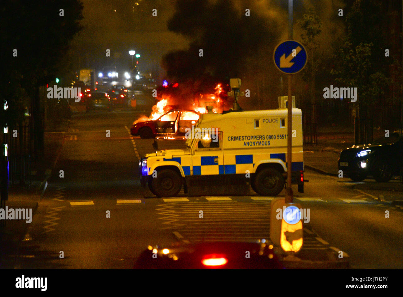 Belfast, Northern Ireland. 09th Aug, 2017. A Car burns in the middle of the road in the New Lodge area of Belfast as PSNI Block the road.  Belfast: UK: 09 AUG Credit: Mark Winter/Alamy Live News Stock Photo