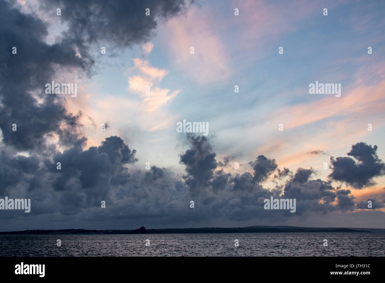 Newlyn, Cornwall, UK. 9th August 2017. UK Weather.  A mix of sunshine and showers at sunrise over Newlyn, with fast moving clouds and a brisk north westerly wind. Credit: Simon Maycock/Alamy Live News Stock Photo