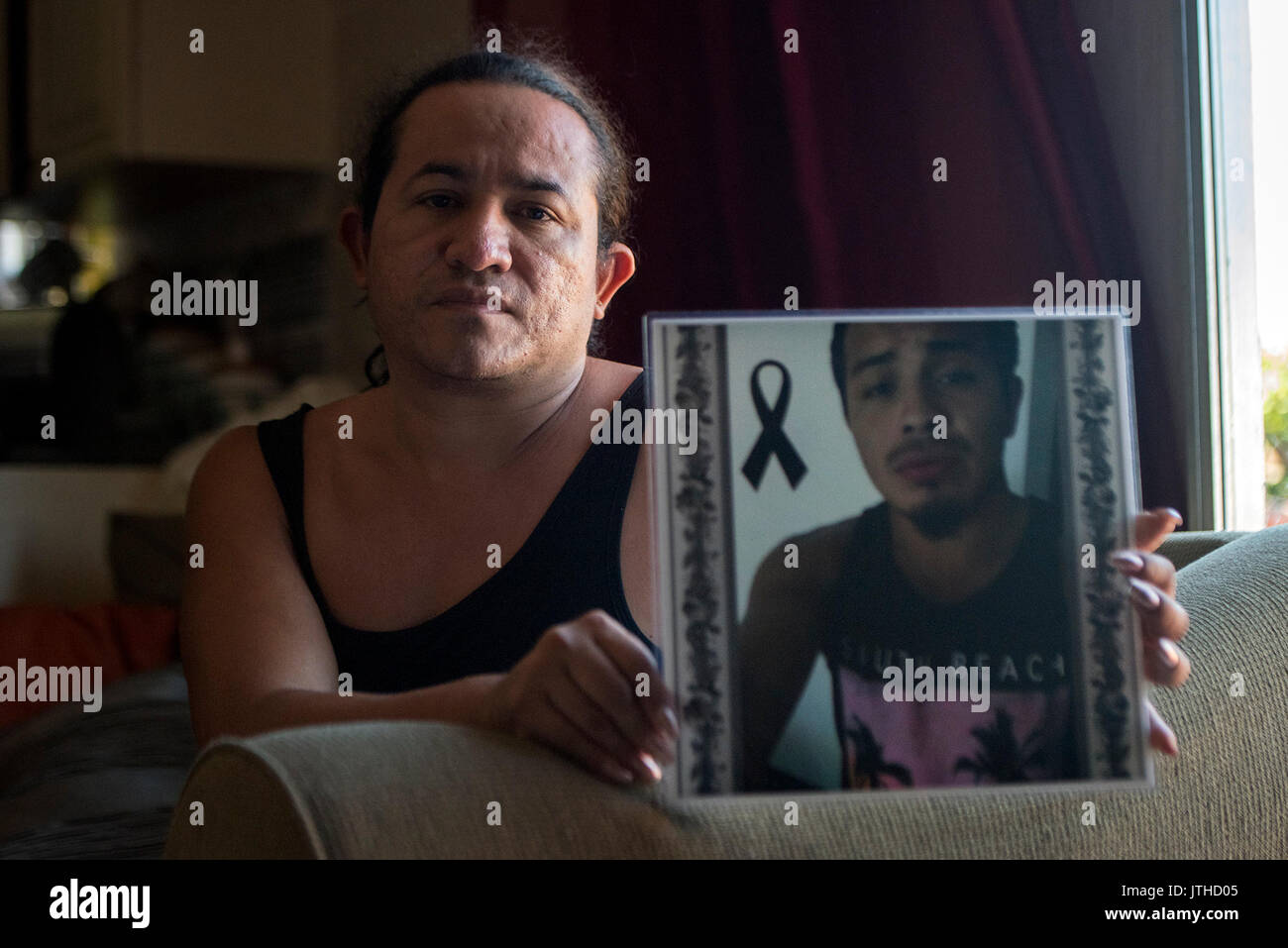 West Palm Beach, Florida, USA. 9th Aug, 2017. Pedro Cruz, 36, poses for a portrait holding a photograph of his late cousin, 22-year-old Juan Cruz, at his aunt's home in Boynton Beach, Fla., on Wednesday, August 9, 2017. Juan was killed August 6 defending Pedro during an altercation outside a Lake Worth restaurant. Credit: Andres Leiva/The Palm Beach Post/ZUMA Wire/Alamy Live News Stock Photo