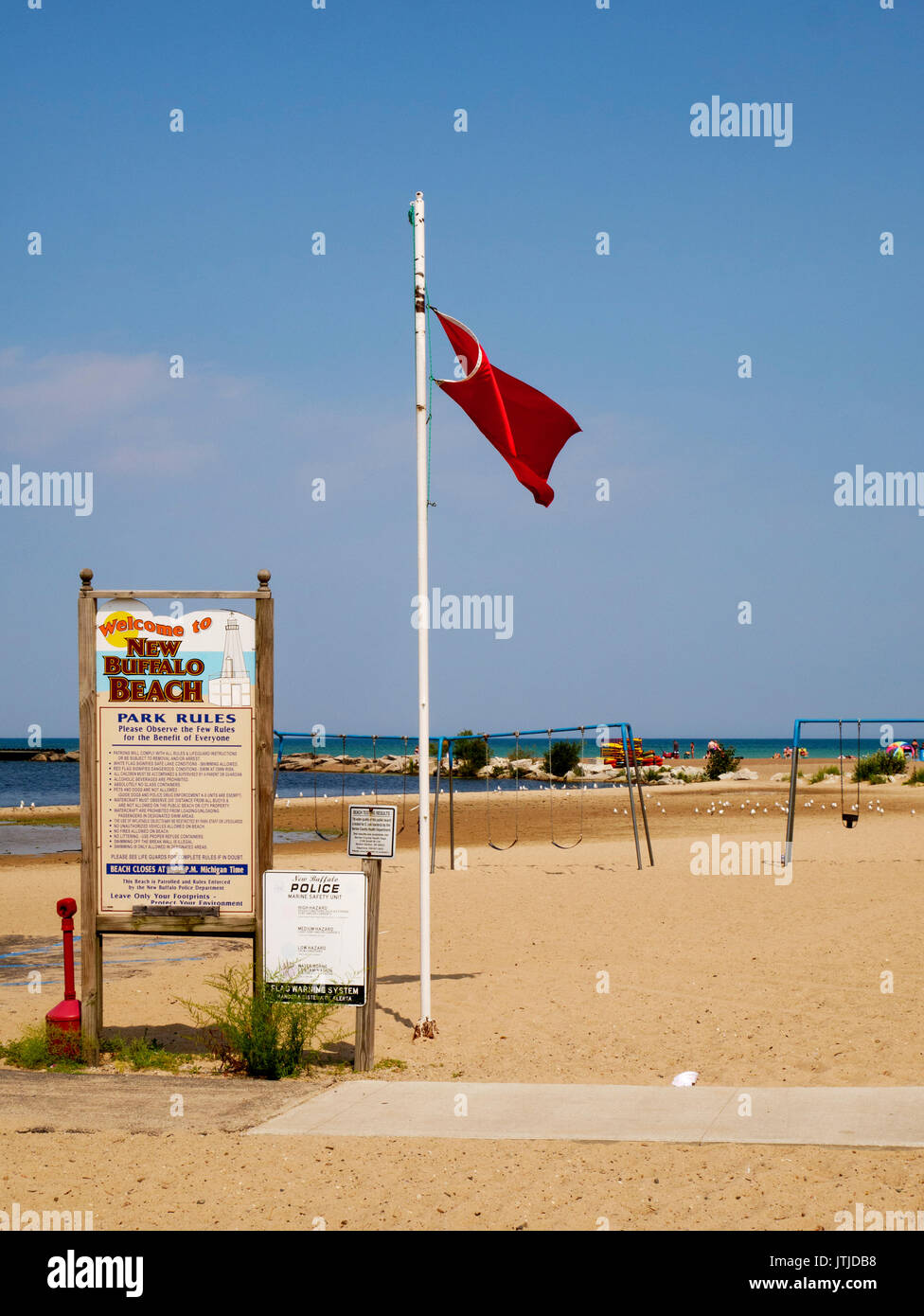 List of rules and red flag indicating hazardous swimming conditions. New Buffalo, Michigan City Beach Stock Photo