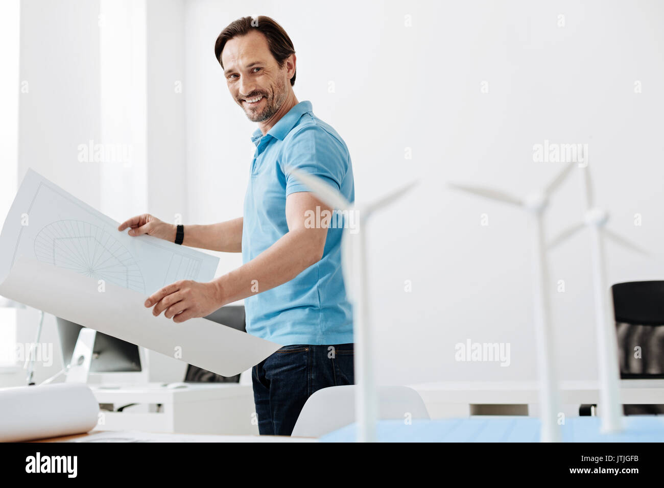 Handsome young engineer checking out wind turbine models Stock Photo