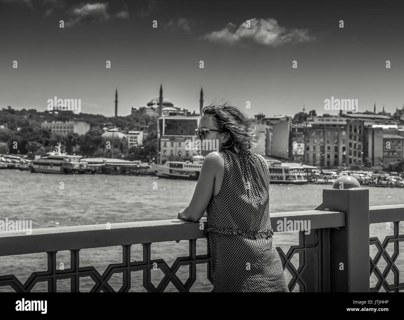 Istanbul, Turkey - July 19, 2017 Woman Watching Istanbul from Galata Bridge Stock Photo