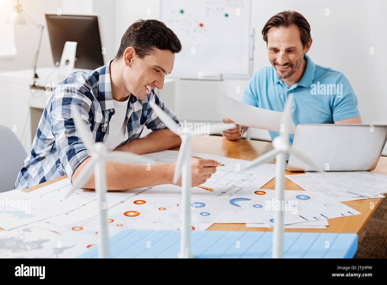 Two engineers being happy to find a mistake in calculations Stock Photo