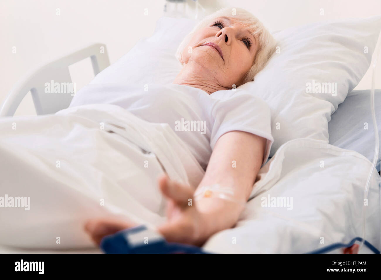 Feeble old lady having her pulse measured Stock Photo