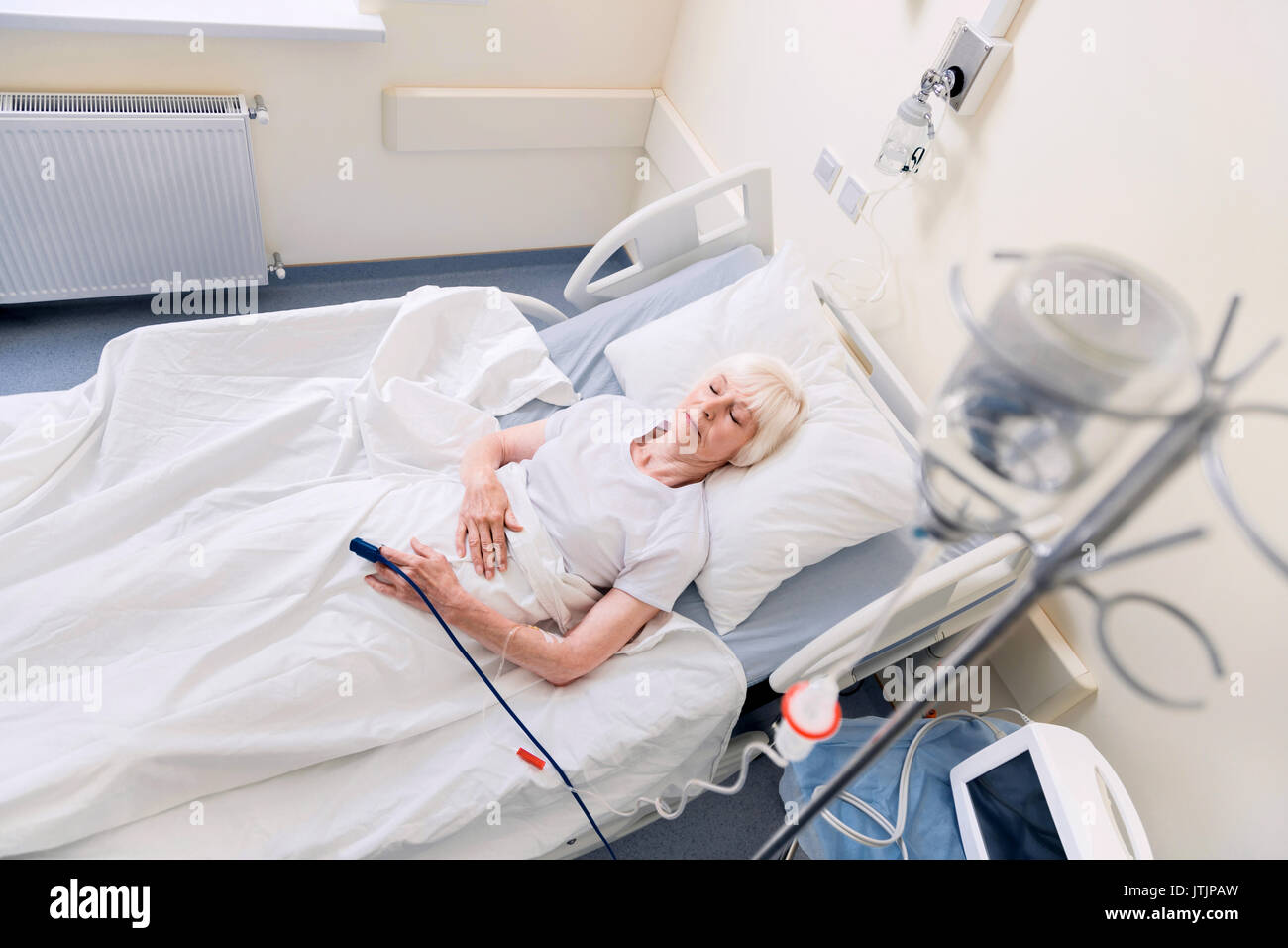 Feeble senior woman resting while recovering Stock Photo