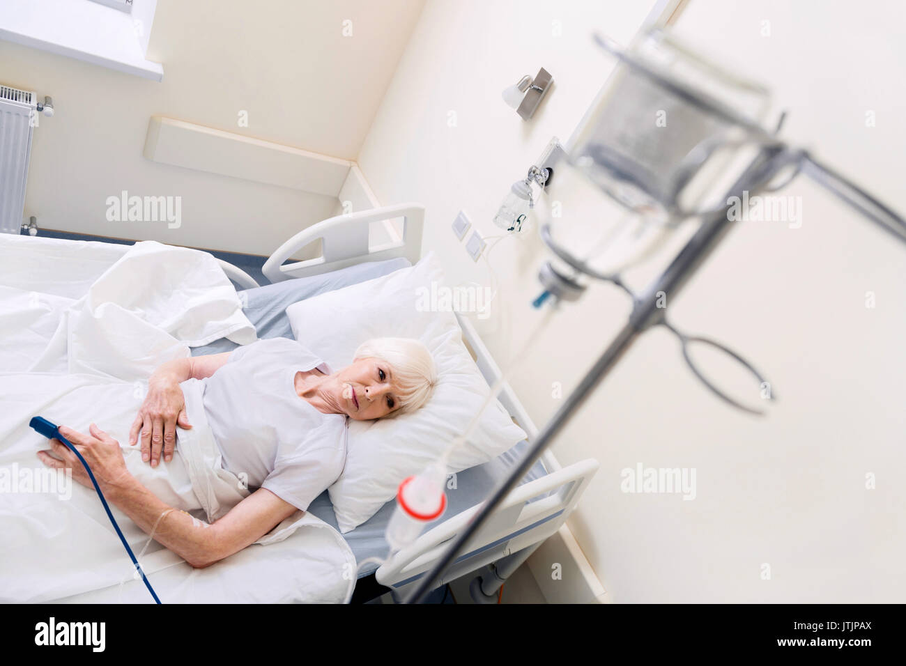 Sore ill woman resting on hospital bed Stock Photo Alamy