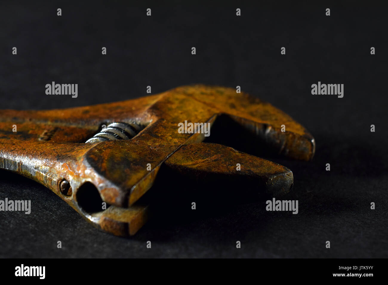 Close up of rusty old wrench on black background. Selective focus Stock Photo