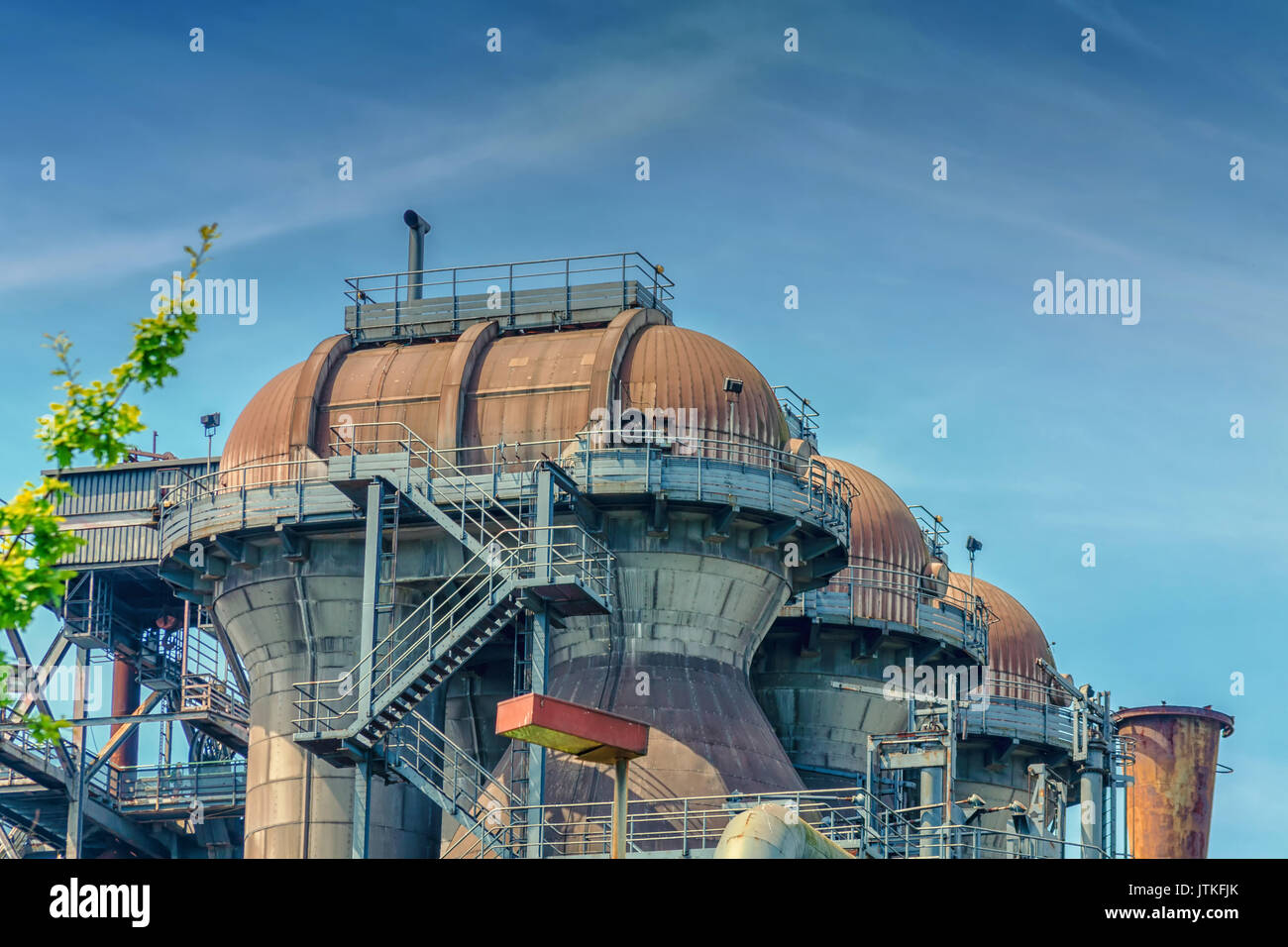 General view of an industrial plant refinery, consisting of pipes and towers of heavy industry. Stock Photo