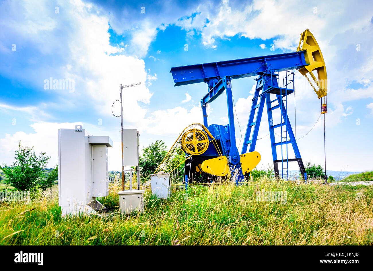 Extraction oil pumps with electrical PLC cabinet. Oil and gas industry landscape. Stock Photo