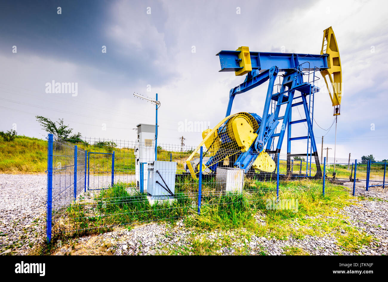 Extraction oil pumps with electrical PLC cabinet. Oil and gas industry landscape. Stock Photo