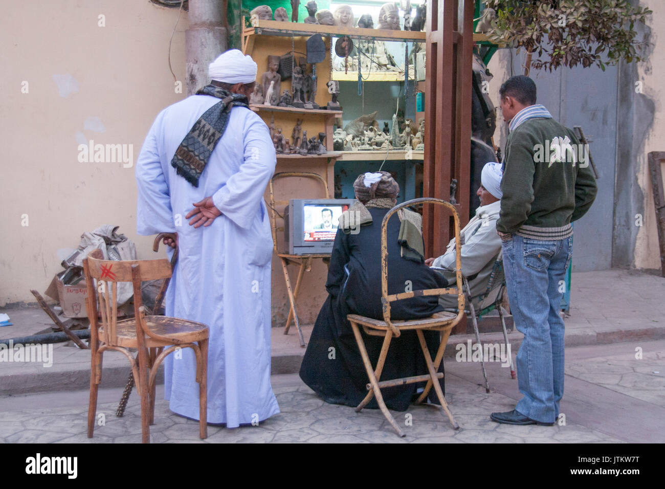 Luxor, Egypt - December 30, 2006: People on the street watching on TV the execution of Saddam Hussein. Stock Photo