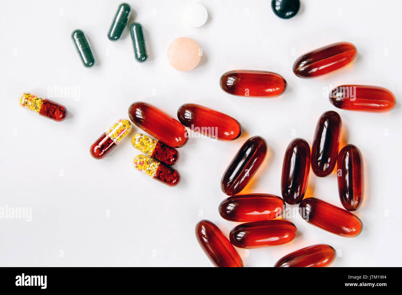 Vitamins and nutrition for good health. Red pills on white background