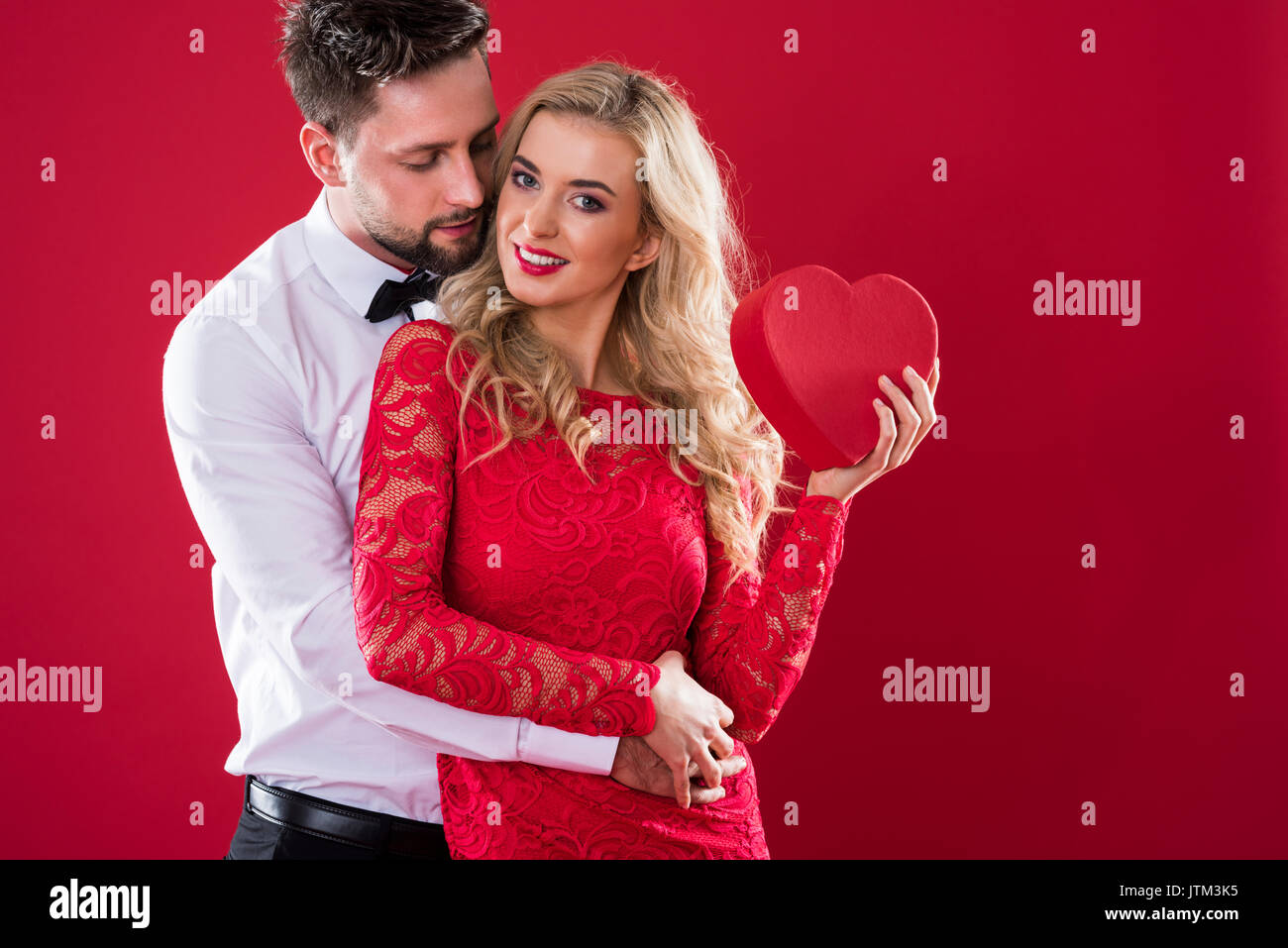 Woman holding red box and smiling wide Stock Photo