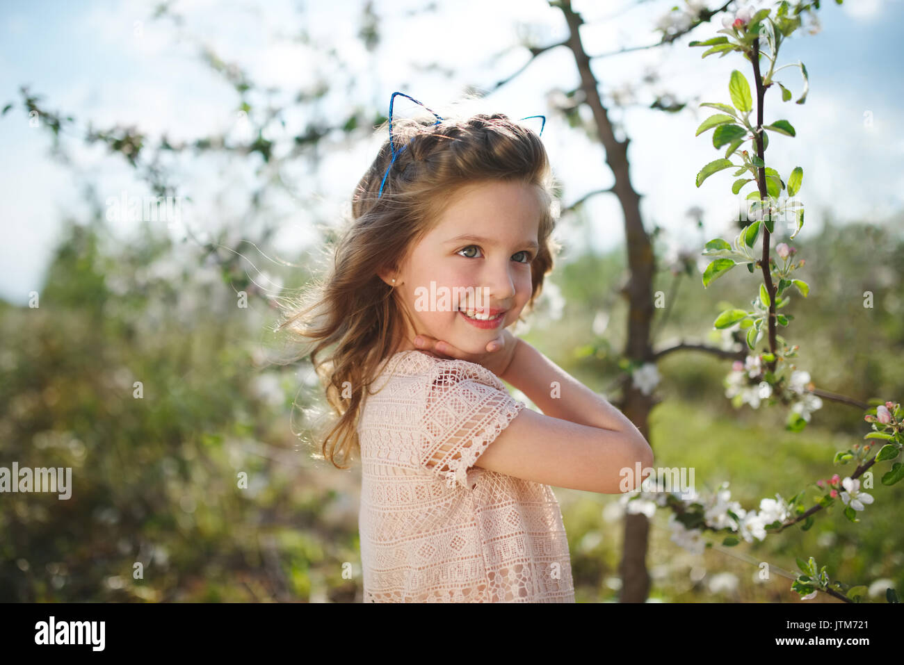beautiful little girl in blooming garden Stock Photo - Alamy