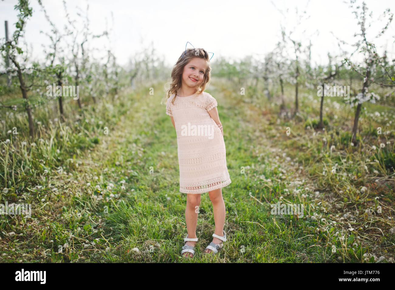 beautiful little girl in blooming garden Stock Photo - Alamy