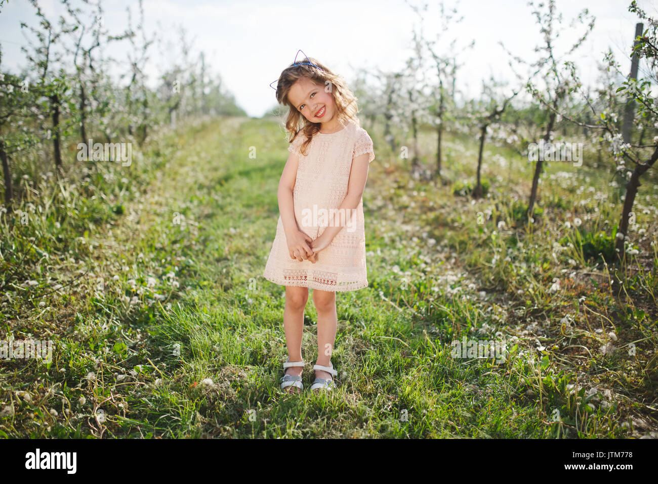 beautiful little girl in blooming garden Stock Photo - Alamy