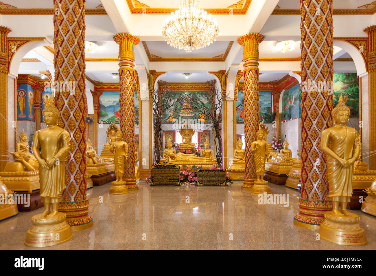 Gilded standing, seated and reclining Buddha statues inside the Viharn hall at Wat Chalong Temple in Phuket, Thailand Stock Photo