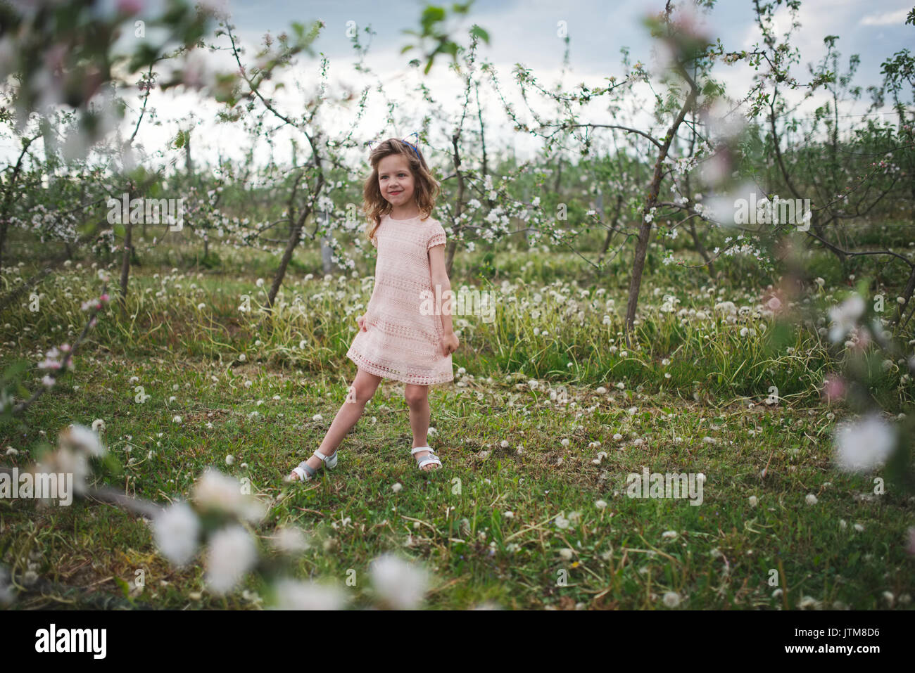 beautiful little girl in blooming garden Stock Photo - Alamy